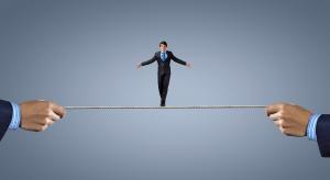 Young brave ricky businessman balancing on rope
